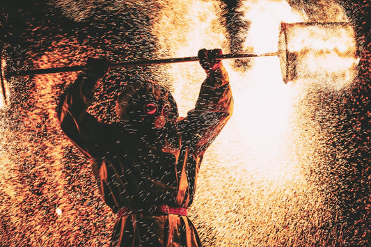 Fire show at night. Black silhouette of man against backdrop of fiery sparks