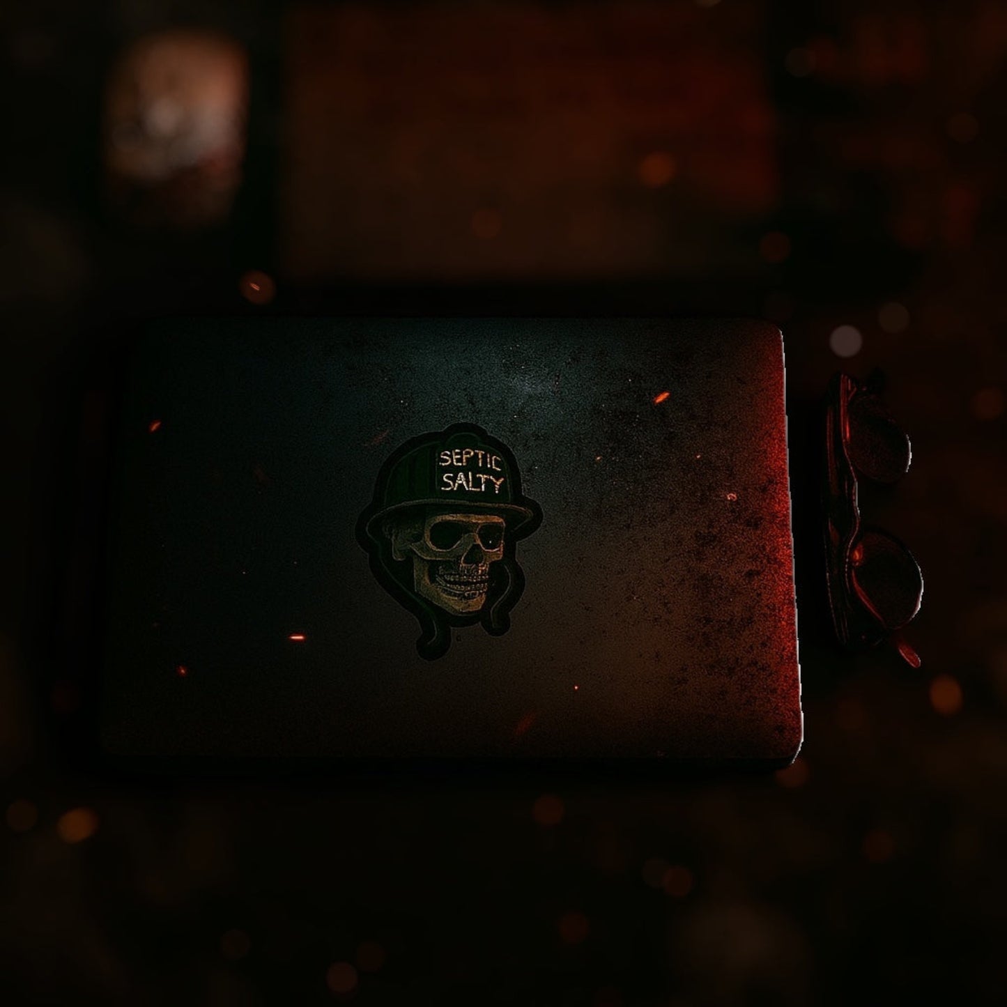 Septic & Salty embroidered skull firefighter sticker with helmet design in forest green and gold on black vinyl.