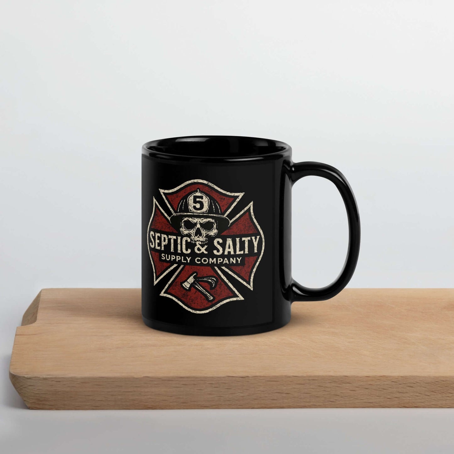 The Septic & Salty Coffee Mug-Firehouse Humor For Firefighters on a wood surface, showcasing firehouse design and identity.