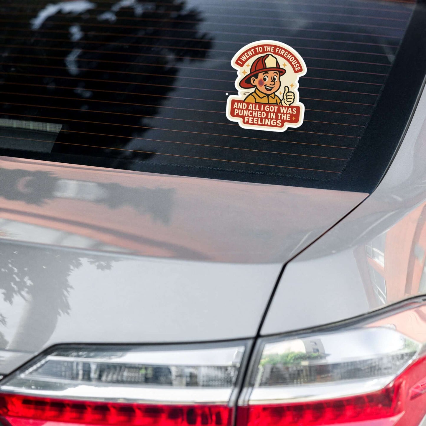 The "Punched in the Feelings" 5.5"×5.5" die-cut sticker on a car window — firefighter humor weatherproof vinyl sticker by Septic & Salty Supply Co.