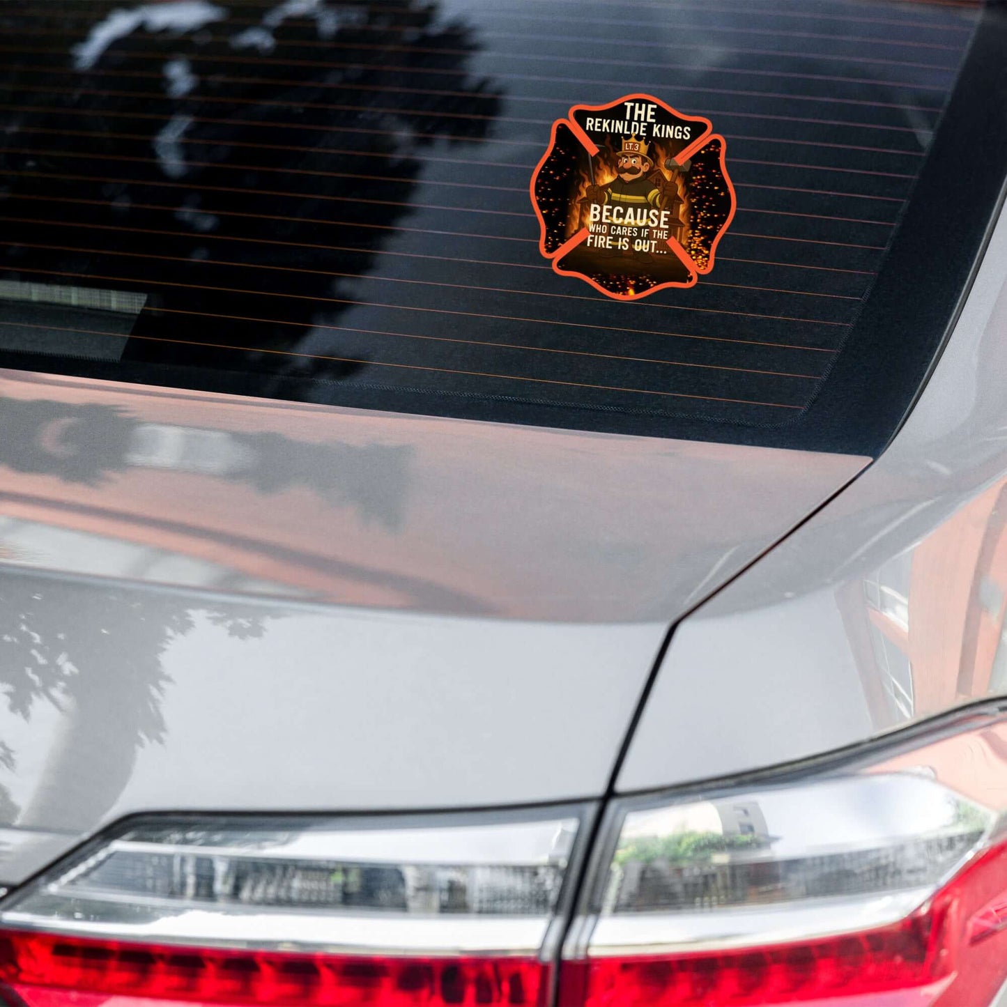 The "Rekindle Kings" 5.5"×5.5" die-cut sticker on a car window — weatherproof firefighter humor vinyl sticker by Septic & Salty Supply Co.