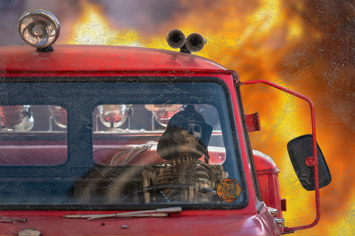 Red fire truck with flames in the background
