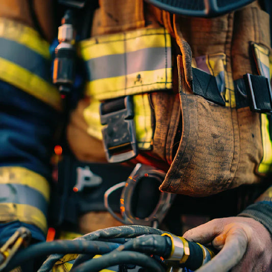 Firefighters supporting each other after a call, symbolizing Brotherhood and burnout firefighter gear resilience.
