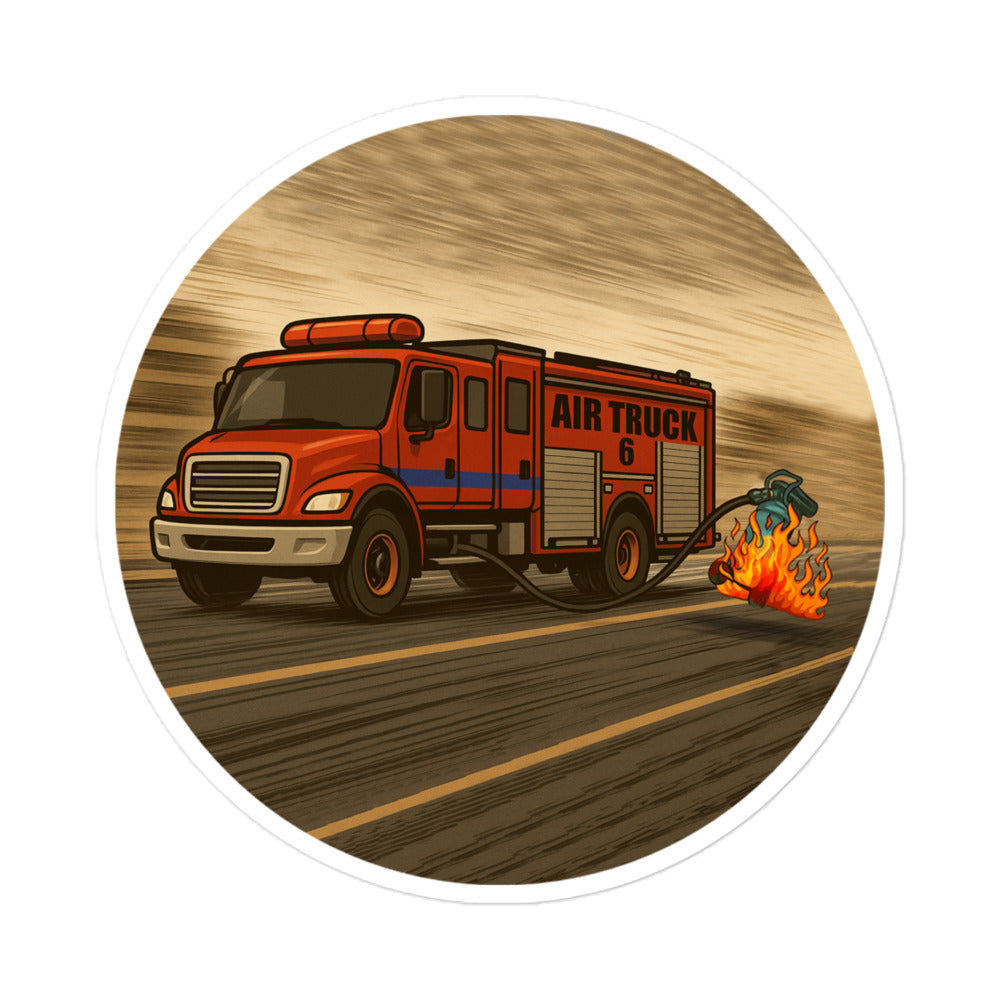 Cartoon firefighter sticker showing a red fire truck labeled “Air Truck 6” driving down a road with a flaming air compressor being dragged behind it.