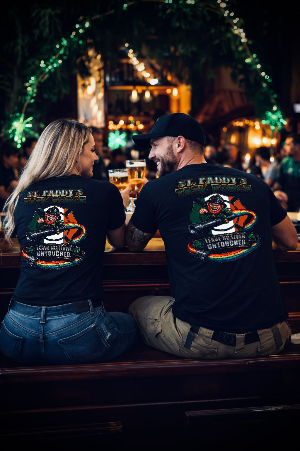 Two people sitting at a bar, wearing matching t-shirts with a graphic design.