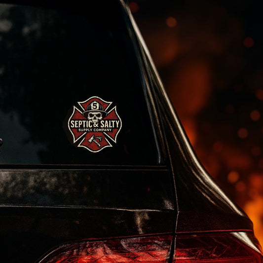 The "Maltese Skull" die-cut sticker applied to vehicle glass with a red glow behind it — Septic & Salty Supply Co. firefighter morale decal.