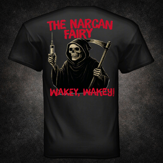 Back view of black t-shirt featuring a grim reaper skeleton holding a syringe and scythe, with red distressed text reading "The Narcan Fairy" and "Wakey, Wakey!" — dark humor EMS and firefighter apparel by Septic & Salty Supply Co.