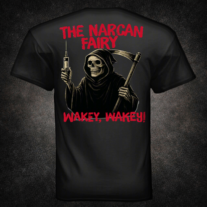 Back view of black t-shirt featuring a grim reaper skeleton holding a syringe and scythe, with red distressed text reading "The Narcan Fairy" and "Wakey, Wakey!" — dark humor EMS and firefighter apparel by Septic & Salty Supply Co.