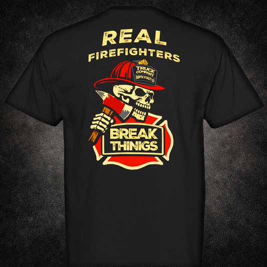 Back view of black t-shirt featuring a skull in a red firefighter helmet holding an axe, with bold text "Real Firefighters Break Things" over a fire department emblem — truck company humor apparel by Septic & Salty Supply Co.