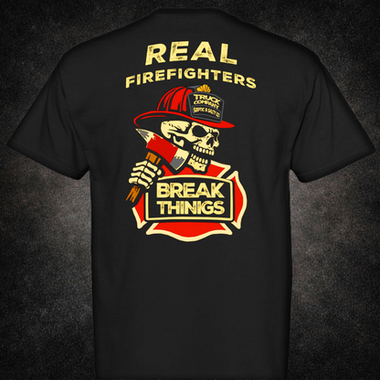 Back view of black t-shirt featuring a skull in a red firefighter helmet holding an axe, with bold text "Real Firefighters Break Things" over a fire department emblem — truck company humor apparel by Septic & Salty Supply Co.