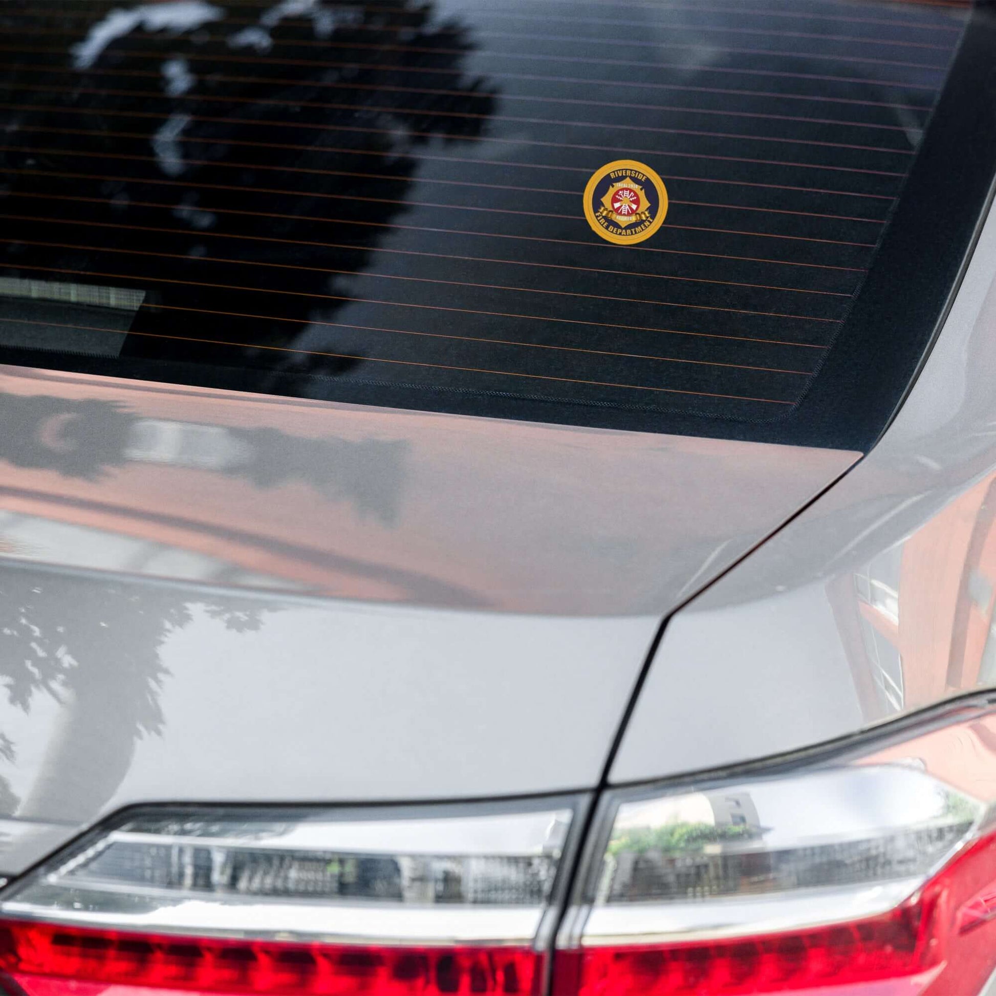 Retiree Sticker on the back window of a car, showcasing firehouse humor and firefighter spirit.