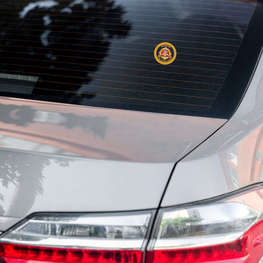 Retiree Sticker on the back window of a car, showcasing firehouse humor and firefighter spirit.
